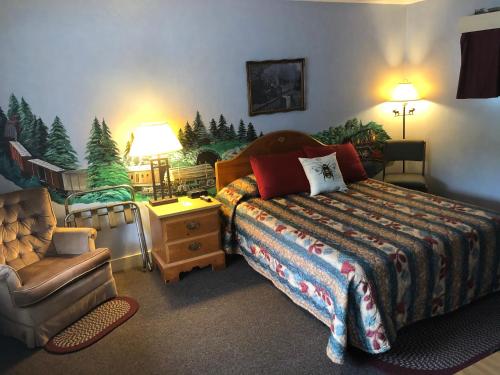 Wells RiverにあるWells River Motelのベッドルーム1室(ベッド1台、椅子、ソファ付)