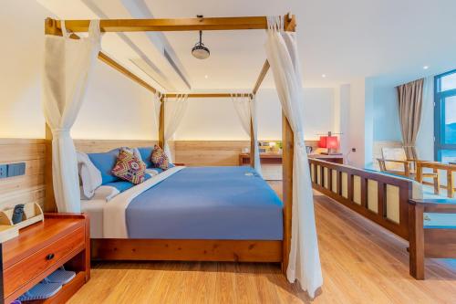 a bedroom with a bed with a canopy at Enshi Grand Canyon Yutan Muyun Guesthouse in Enshi