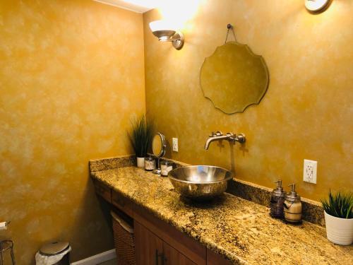 a bathroom with a bowl sink in a counter at UPDATED Amazing Bi -Level Condo minutes from water views of New York City in North Bergen