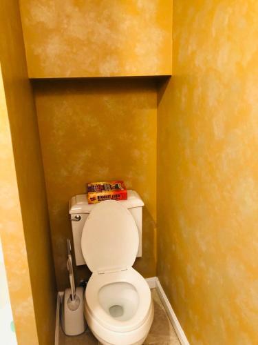 a small bathroom with a toilet with a book on it at UPDATED Amazing Bi -Level Condo minutes from water views of New York City in North Bergen