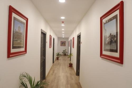 a hallway with pictures on the walls of a building at Click Hotel Transport Nagar in Lucknow