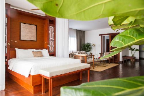 a bedroom with a bed and a living room at Amanjaya Pancam Suites Hotel in Phnom Penh