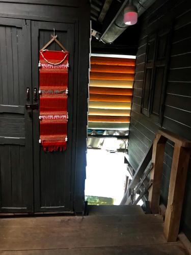 a pair of red towels hanging on a door at Pano Solar Guest House (พาโน โซล่า เกสเฮ้าส์ ) in Trat