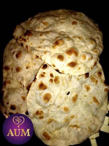 a close up of a pizza at Aum Hotel in Puttaparthi