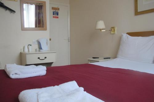 Ένα ή περισσότερα κρεβάτια σε δωμάτιο στο Chiswick Lodge Hotel