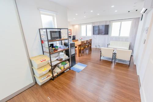 a living room with a kitchen and a dining room at Port House Shibuya in Tokyo