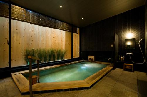 a swimming pool in a room with a large window at Ochanomizu Hotel Shoryukan in Tokyo