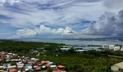 an aerial view of a city and a body of water at BH Mangrove Condos in Mactan