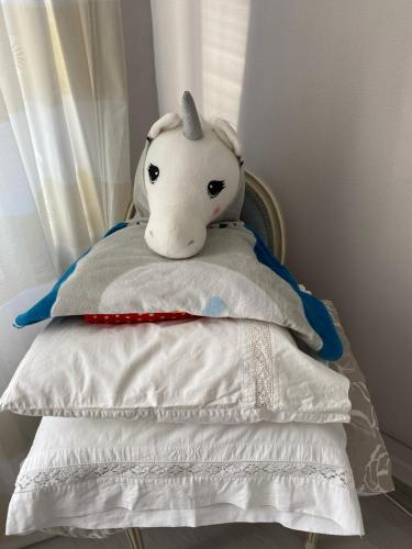 a stuffed elephant sitting on top of a pillow at Skrunda Apartments Centrum in Skrunda