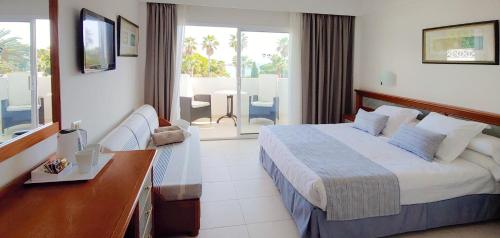 a hotel room with a bed and a balcony at Hotel Rocamarina - Adults Only in Cala d´Or