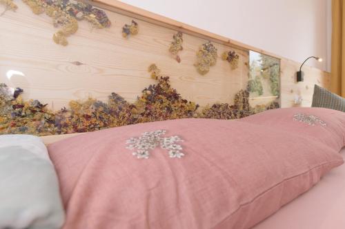 a pink bed with a pink blanket on it at Ferienwohnung Berg Wieserhof in Aldino