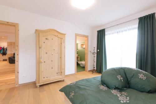 a bedroom with a bed and a large window at Ferienwohnung Wies Wieserhof in Aldino