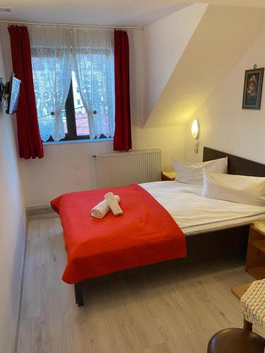 a bedroom with a bed with two towels on it at Pensiune Turist in Sibiu