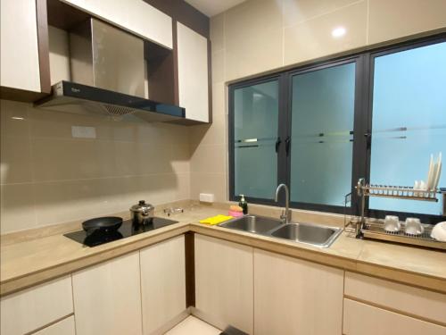 a kitchen with a sink and a large window at AZ Hotel & Serviced Apartments in Labuan