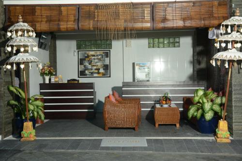 a restaurant with chairs and a table and a counter at Kubu Garden Suites & Villas Nusa Dua in Nusa Dua