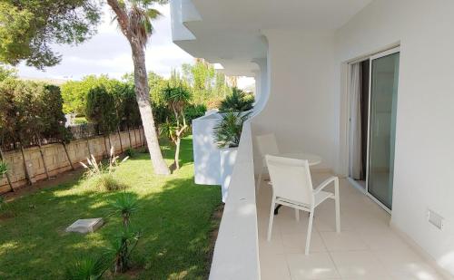 a room with a table and a chair on a balcony at Hotel Rocamarina - Adults Only in Cala d´Or