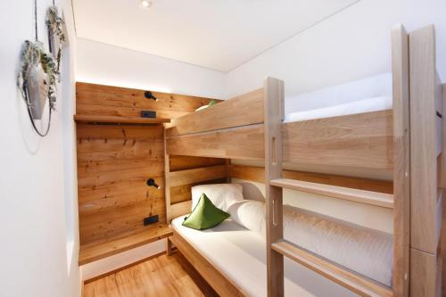 a bunk bed in a room with wooden walls at Ferienwohnung Saxenhammer in Vandans