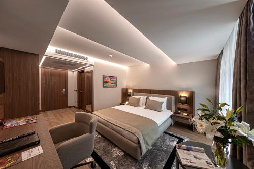 Vital Hotel Fulya Istanbul Sisli في إسطنبول: غرفة الفندق بسرير وطاولة