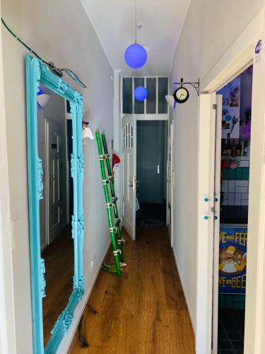a hallway with a mirror and a ladder on the wall at Blue Edition Cologne in Cologne