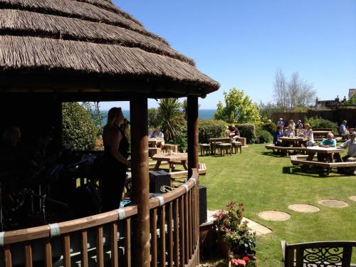 a group of people sitting at tables in a garden at The Mariners Hotel in Lyme Regis