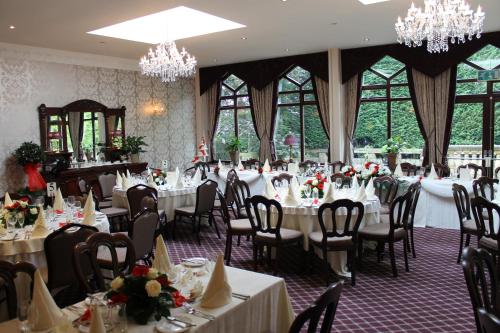 a dining room filled with tables and chairs at Oakwood Hall Hotel in Bingley