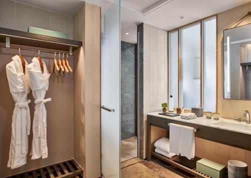 a bathroom with a sink and a mirror at Rosewood Sanya in Sanya