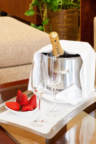 a tray with wine glasses and strawberries on a table at Hotel Royal Plaza in Ibiza Town