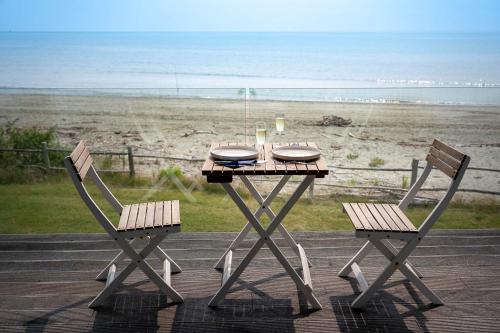 a table and two chairs with a view of the beach at The Waters in Motueka