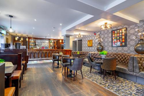 a restaurant with tables and chairs and a bar at Banchory Lodge Hotel in Banchory