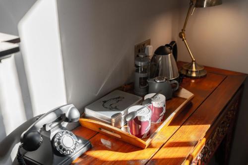 a wooden table with a clock on top of it at Banchory Lodge Hotel in Banchory