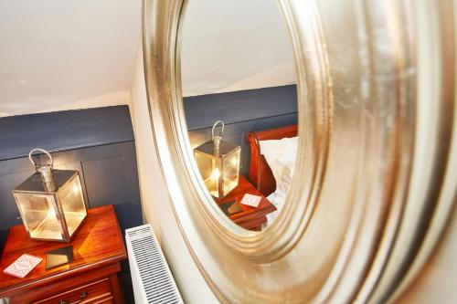 a mirror in a room with a bed and a bed at Dillons of Whitby in Whitby
