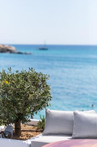 a couch on the beach with the ocean in the background at Santana Beach in Agia Anna Naxos