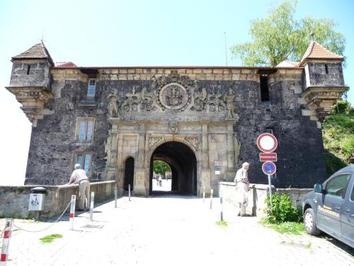 an entrance to a stone building with two men standing outside at Hotel Am Schloss *** Superior in Tübingen