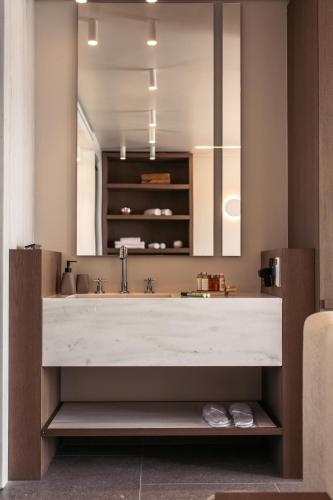 a bathroom with a large sink and a mirror at Santana Beach in Agia Anna Naxos