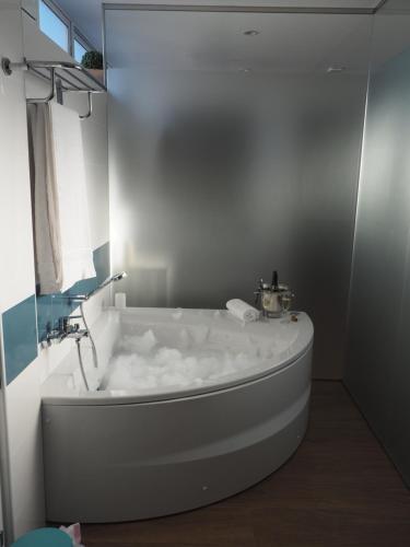 a white bath tub in a bathroom with a window at Ardales Loft in Ardales