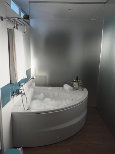 uma banheira branca na casa de banho com uma janela em Ardales Loft em Ardales