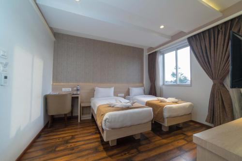 Tempat tidur dalam kamar di Hotel Samudra