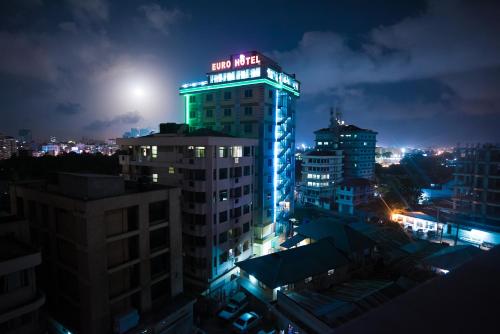 a lit up building in a city at night at Euro Hotel and Apartments in Dar es Salaam
