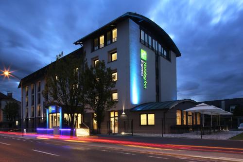 a building with a blue lit up sign on it at Holiday Inn Express - Ljubljana by IHG in Ljubljana