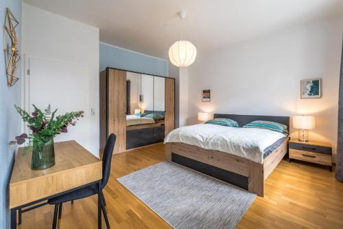 a bedroom with a bed and a table and a desk at Große Freiheit in Leipzig