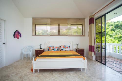a bedroom with a bed and a balcony at Franky Villa in Boracay