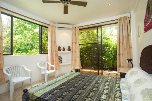 a bedroom with a bed and a large window at Franky Villa in Boracay
