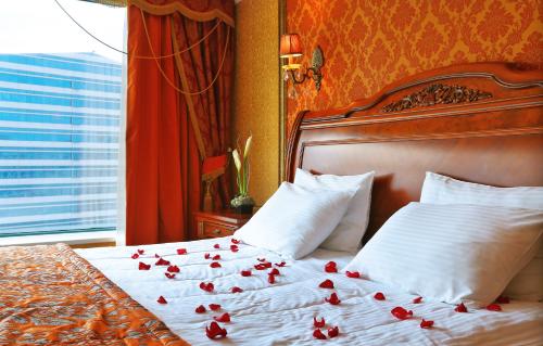 a bedroom with a bed with red roses on it at Diplomat Hotel by AG Hotels Group in Astana