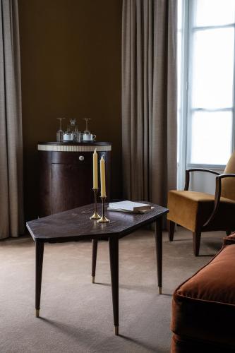 a living room with a table with two candles on it at Hotel Rochechouart - Orso Hotels in Paris