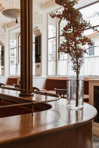 a vase with a plant sitting on a table at Hotel Rochechouart - Orso Hotels in Paris