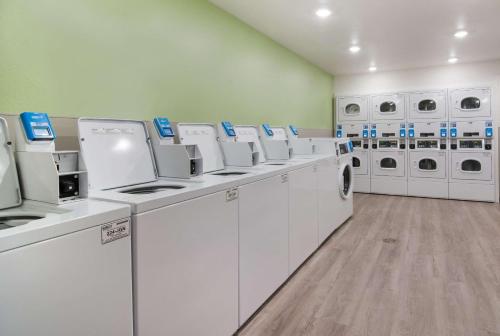 a laundry room with white washers and dryers at WoodSpring Suites Fort Mill in Fort Mill
