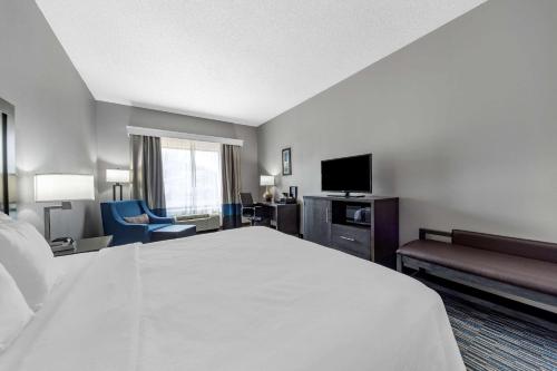 a hotel room with a large bed and a television at Garner Oklahoma City - Quail Springs, an IHG Hotel in Oklahoma City