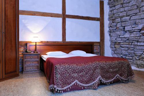 a bedroom with a bed and a large window at St.Olav Hotel in Tallinn