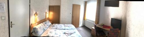 Una cama o camas en una habitación de Hotel Terminus