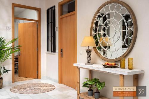 a hallway with a door and a mirror on the wall at MH Apartments Central Sevilla in Seville